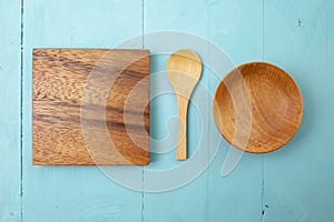 wooden little spoon, square chopping board, and bowl