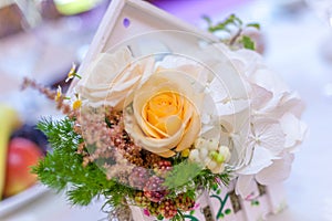 Wooden little white houses with flower arrangements