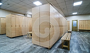 Wooden lockers with a wood bench in a locker room