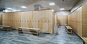 Wooden lockers with a wood bench in a locker room