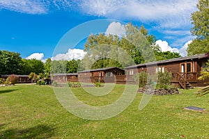 Wooden lodges sit amongst beautiful green grass