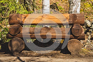 Wooden log bench in the forest