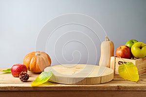 Wooden log board with pumpkin and apples on table. Thanksgiving or Halloween holiday  mock up for design and product display