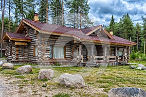 A wooden log cabin in pine forest