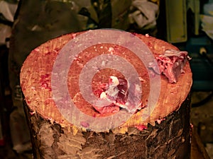 Wooden log that has been used to cut pork with traces of blood