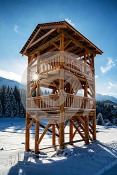 Wooden lookout on snowy winter country