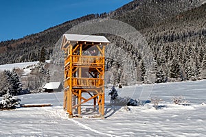 Wooden lookout on snowy winter country