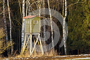 Wooden lookout tower for hunting in the woods and on meadow