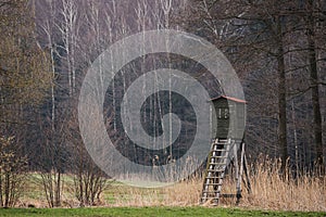 Wooden lookout tower for hunting in the woods and on meadow