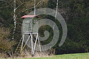 Wooden lookout tower for hunting in the woods and on meadow