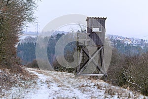 Wooden lookout tower for hunting in the woods and on meadow