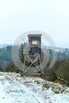 Wooden lookout tower for hunting in the woods and on meadow