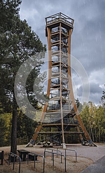 Wooden lookout tower in rainy weather.