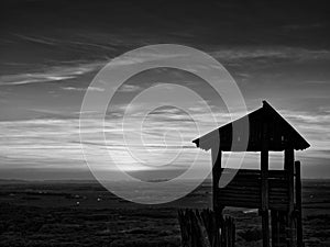 Wooden lookout tower and sunset in black and white from Braunsberg mountain, Austria