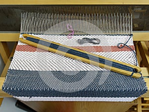 Wooden loom tools on a loom close up