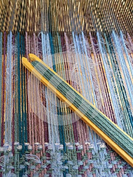 Wooden loom tools on a loom close up