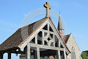 Wooden lychgate with church