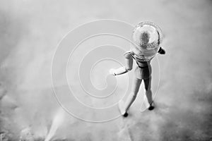 Wooden man on the background with a jar .