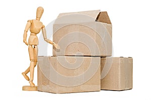 Wooden man next to a cardboard box isolates