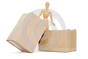 Wooden man next to a cardboard box isolates