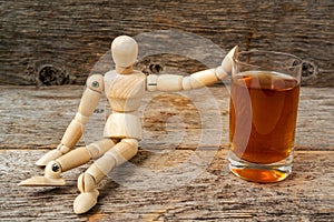 Wooden man showing stop gesture and refusing to drink