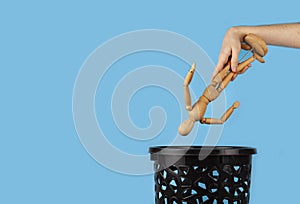 Wooden man are thrown in the trash can