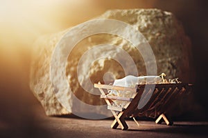 Wooden manger and star of Bethlehem in cave, nativity scene background. Christian Christmas concept. Birth of Jesus