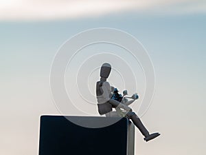 Wooden mannequin with a bouquet of closed flowers in his arms on springtime Solitude and Love concept