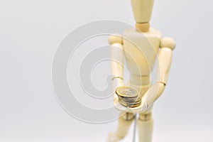 Wooden mannequin with coins photo