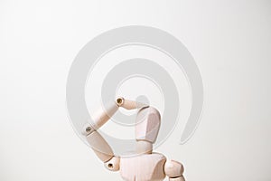 Wooden mannequin with doubtful gesture on white background - confusion and asking question concept
