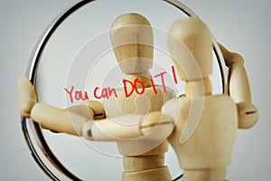 Wooden mannequin looking at himself in the mirror with the motivational message You can Do it! - Concept of self-reflection and photo
