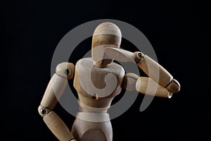 Wooden Mannequin Looking Sad And Depressed On Black Background