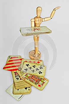 Wooden mannequin with playing cards