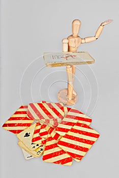 Wooden mannequin with playing cards