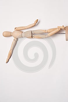 wooden mannequin posing on light background toy object