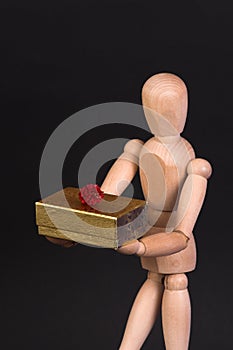 A wooden mannequin with present