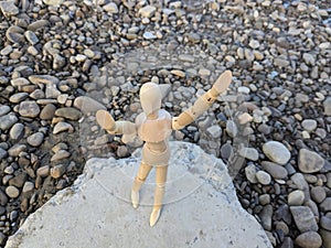 The wooden mannequin raised his hands to faith, showing a plea, a cry for help.