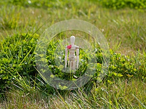 Wooden mannequin with a red heart on his chest. Concept of romanticism and love