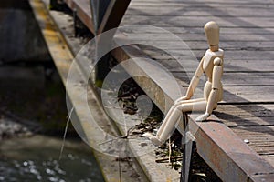 Wooden mannequin sitting