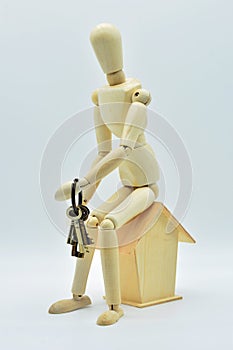 Wooden mannequin sitting in a house photo