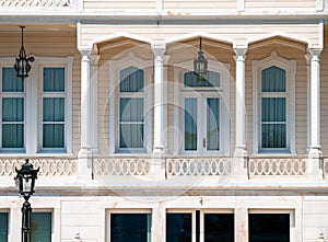 Wooden mansion close up detail. Beautiful classic architecture balcony with arch  columns and many windows