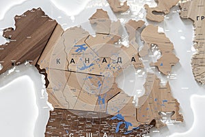 Wooden map of Canada and neighboring countries, names of countries in Russian. Map for trip planning