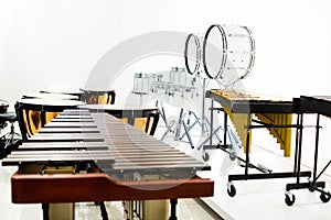 Wooden marimba with blurry marching band instrument in musical showroom