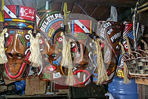 Wooden masks of native amazonian people at a curio stall. Location: Mercado Ver o Peso, Belem, State of Para, Amazon region,