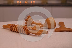 Wooden massage tools, madero therapy materials on spa salon table, anti cellulite concept