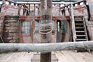 Wooden mast on an ancient sailing ship. Deck of an old pirate frigate