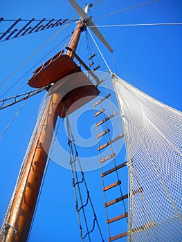 Wooden mast and white netlike sail