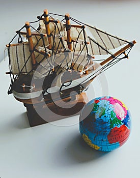 Wooden Masted Ship Model And Globe Isolated In Old Photo Style