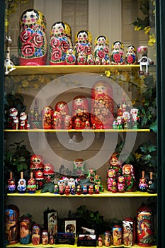 Wooden matryoshka dolls in glass showcase cabinet of local souvenirs gifts toys shop for czechia people and foreign travelers buy