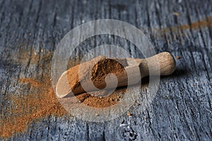 Wooden measuring scoop full of camu-camu powder photo